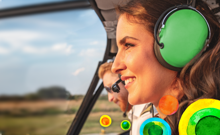 man and woman smiling in a helicopter