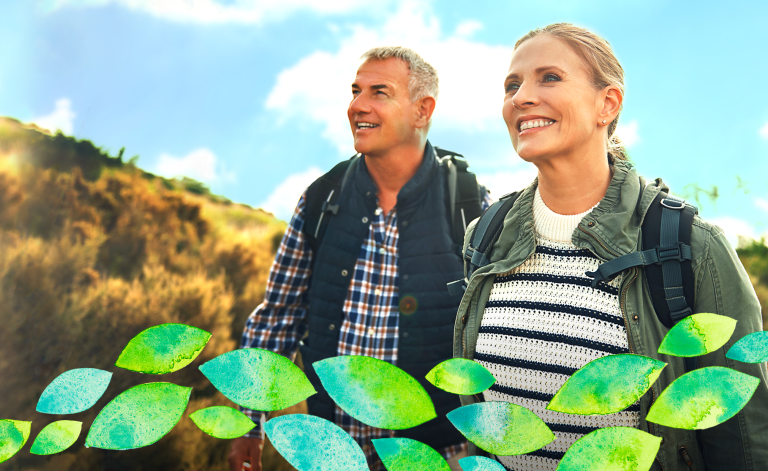 man and woman hiking and smiling